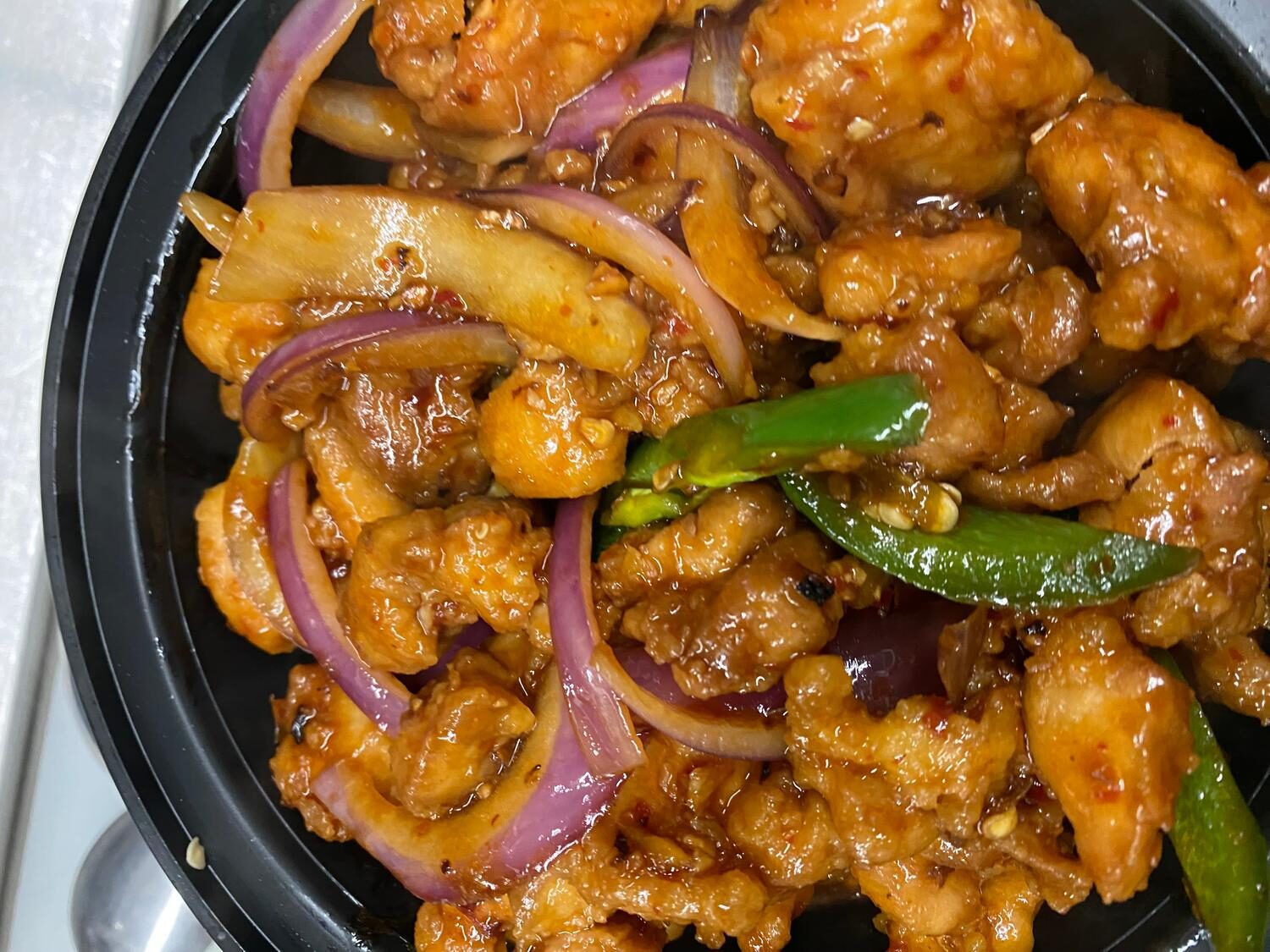 Indo-Chinese chilli chicken with red onions and green chillies