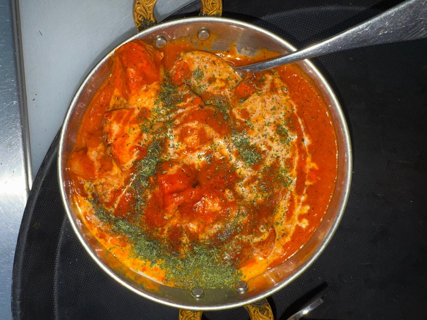 Chicken tikka masala in a copper karahi with cream and dried fenugreek