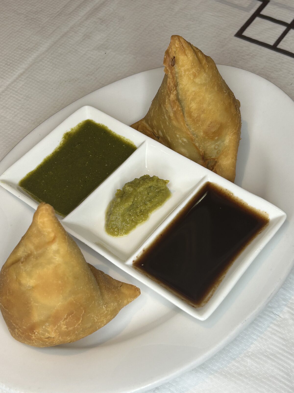 Golden vegetable samosas with mint and tamarind chutneys