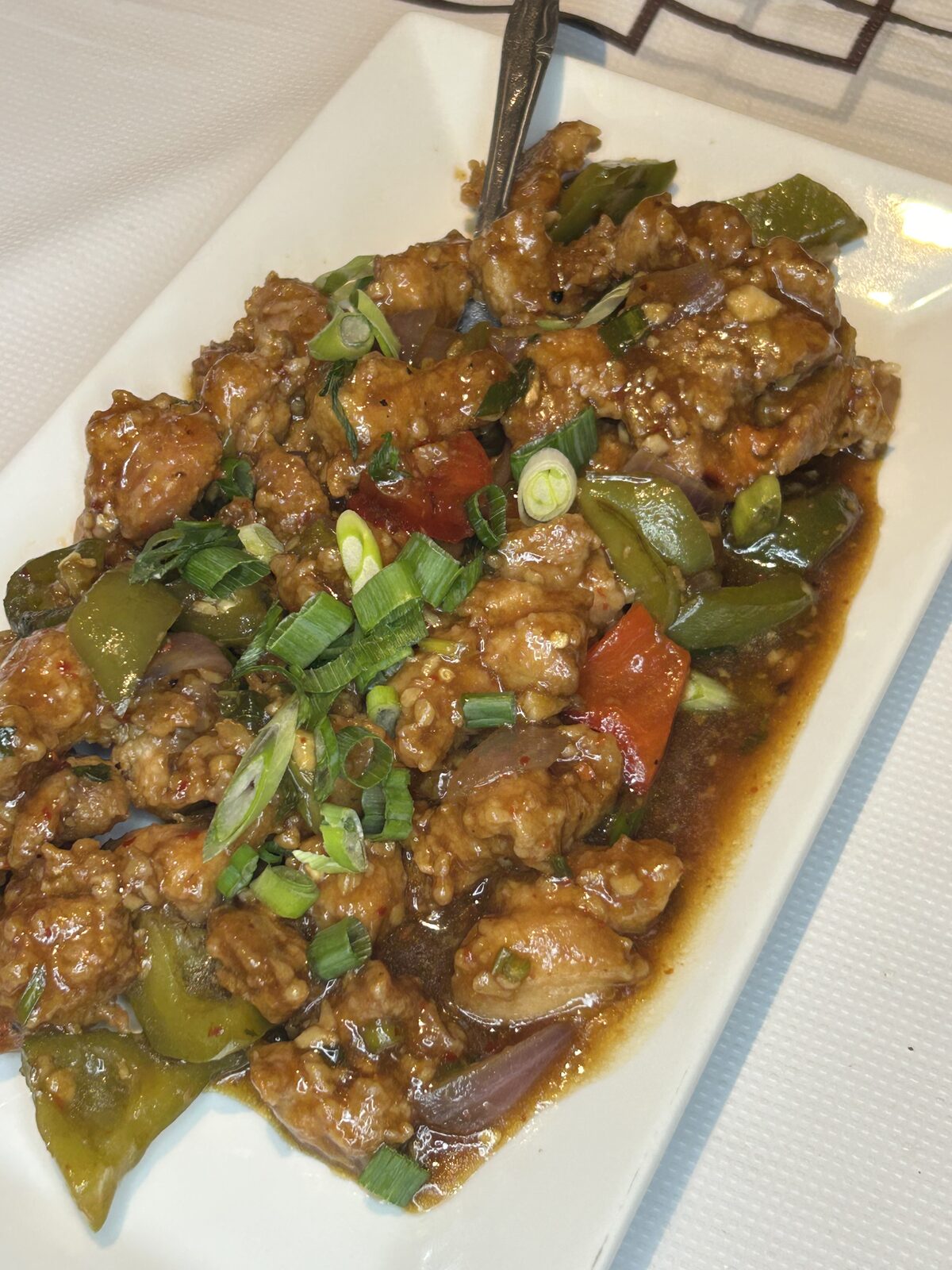 Indo-Chinese chilli chicken with bell peppers and scallions