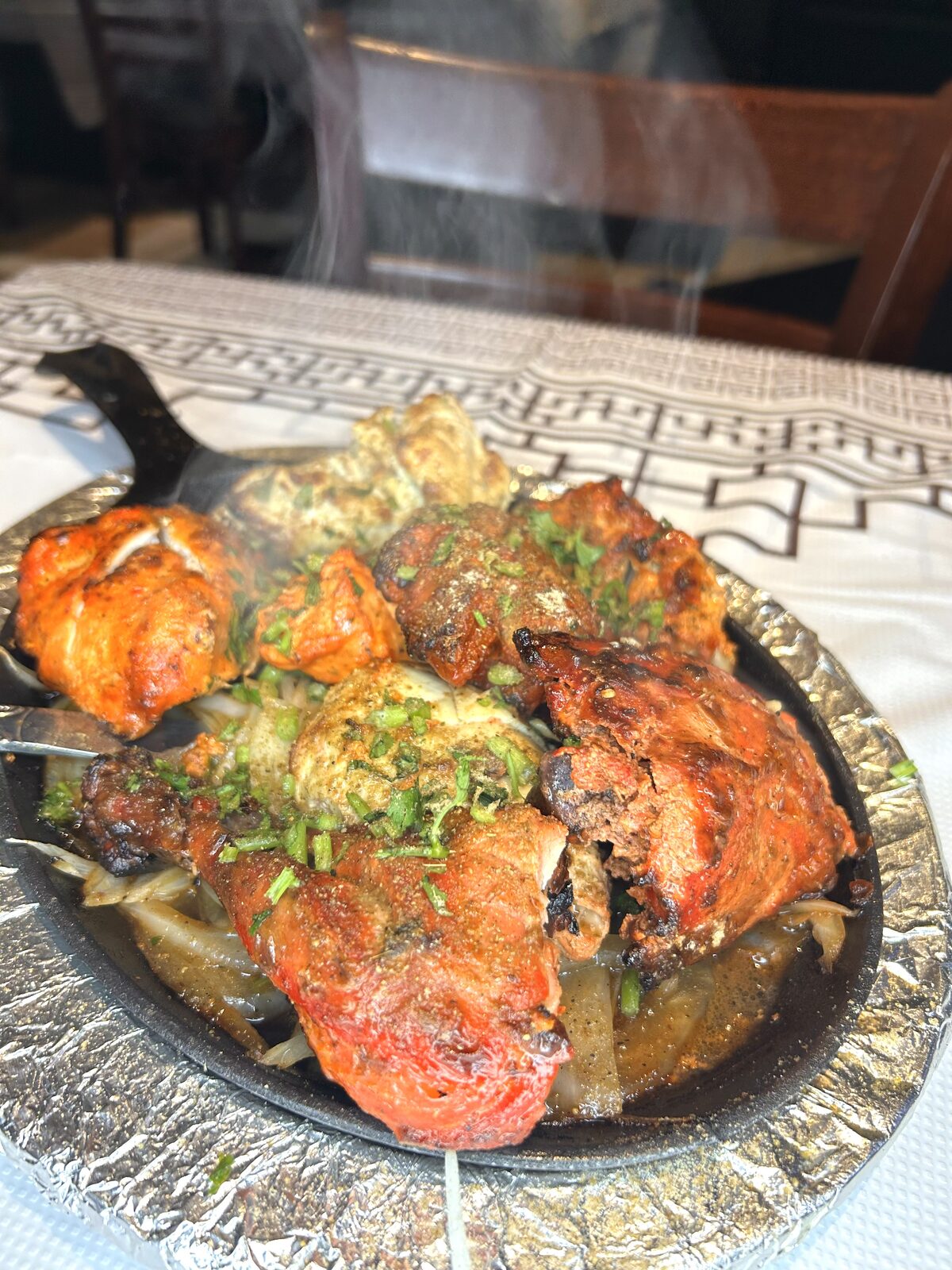 Steaming hot tandoori mixed grill platter fresh from the tandoor