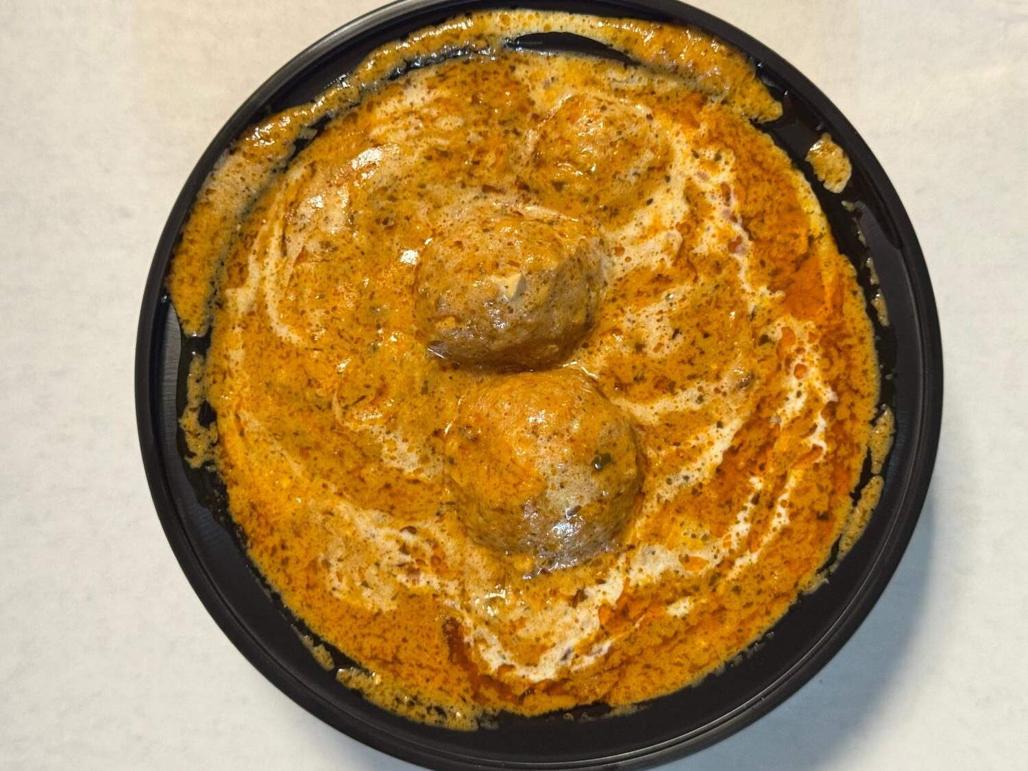 Malai kofta — vegetable dumplings in creamy tomato cashew gravy