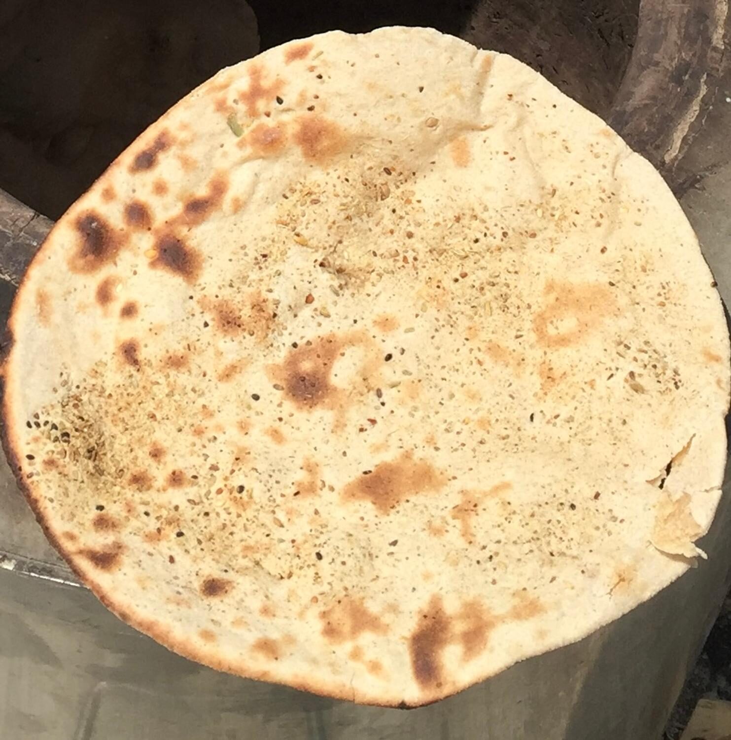 Tandoori roti fresh out of the clay oven with charred spots