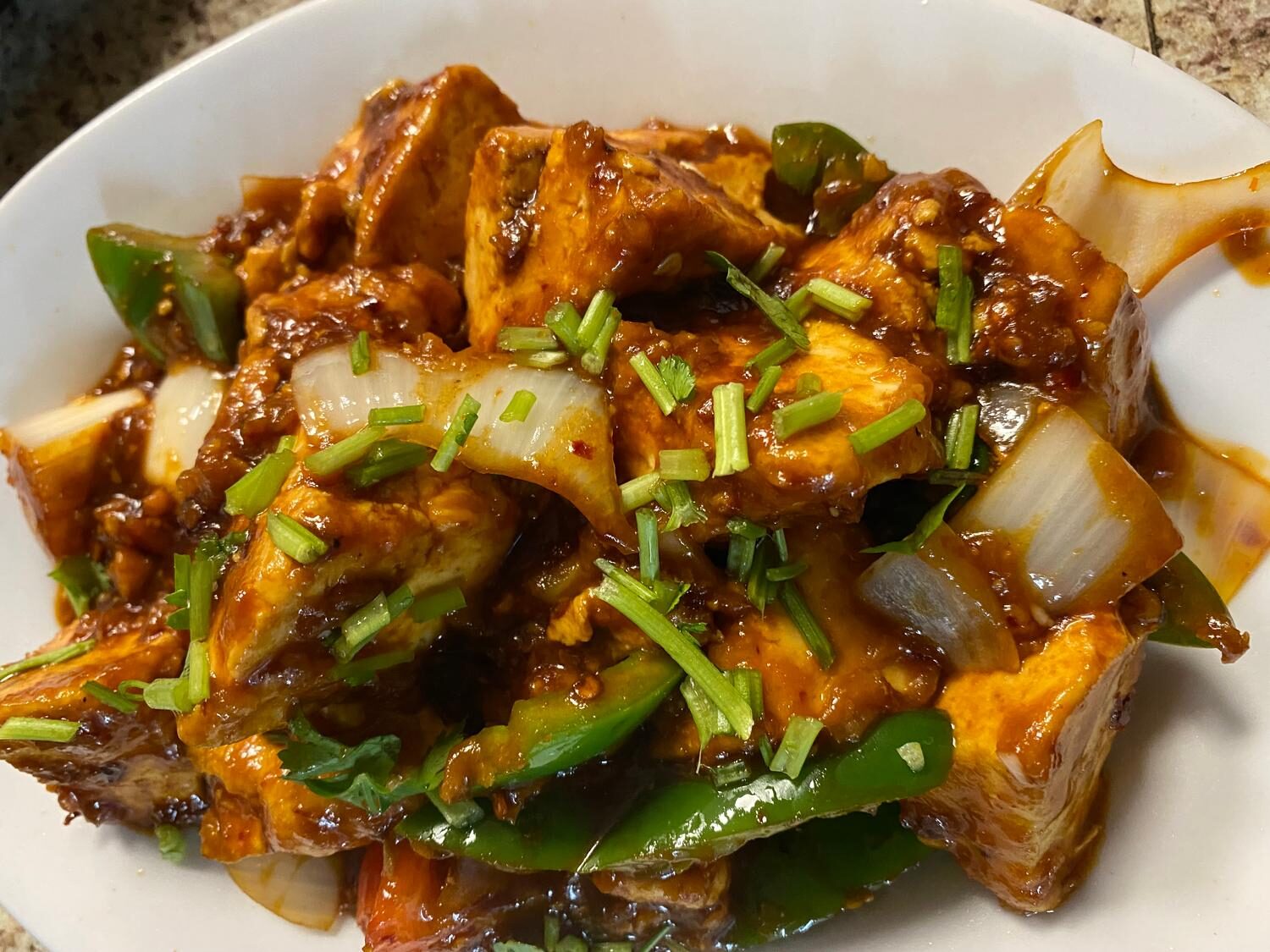 Chilli paneer cubes glazed in Indo-Chinese sauce with peppers and scallions