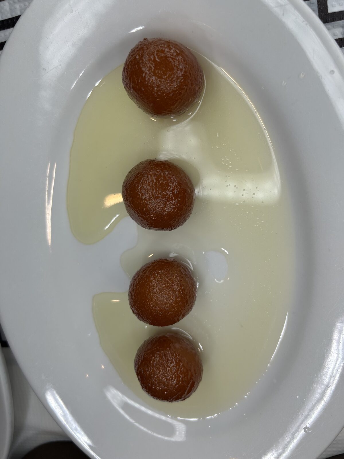 Gulab jamun — golden milk dumplings in cardamom syrup