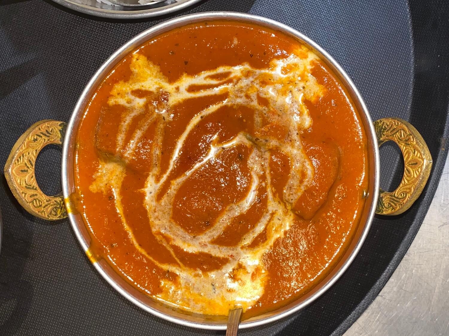 Butter chicken in a copper karahi at INDE SPICE
