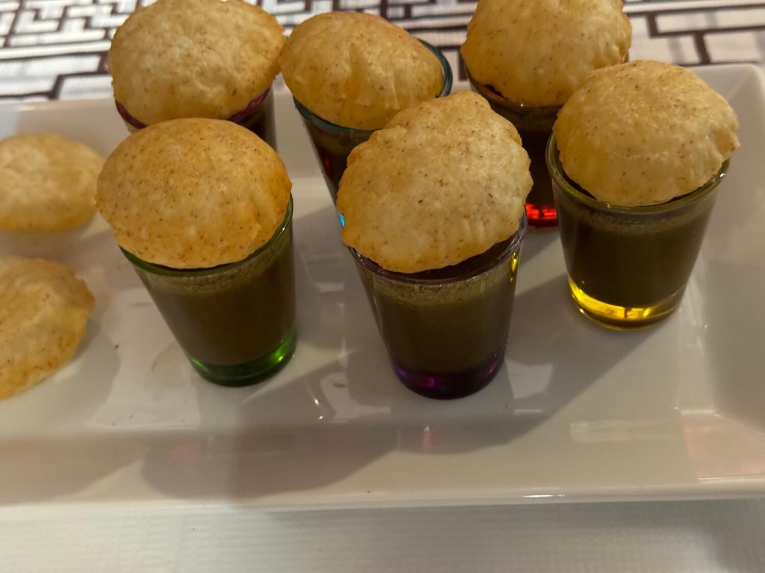 Pani puri shots — crispy puris filled with spiced tamarind and mint water