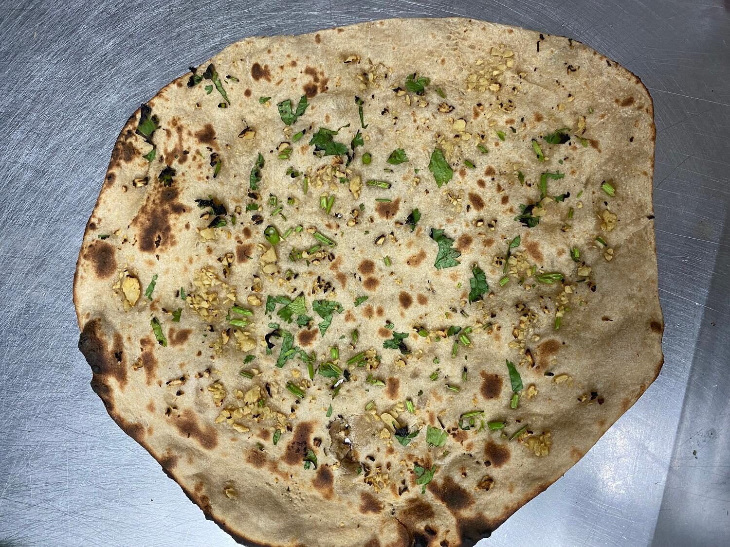 Tandoor-baked garlic roti topped with fresh cilantro and chopped garlic