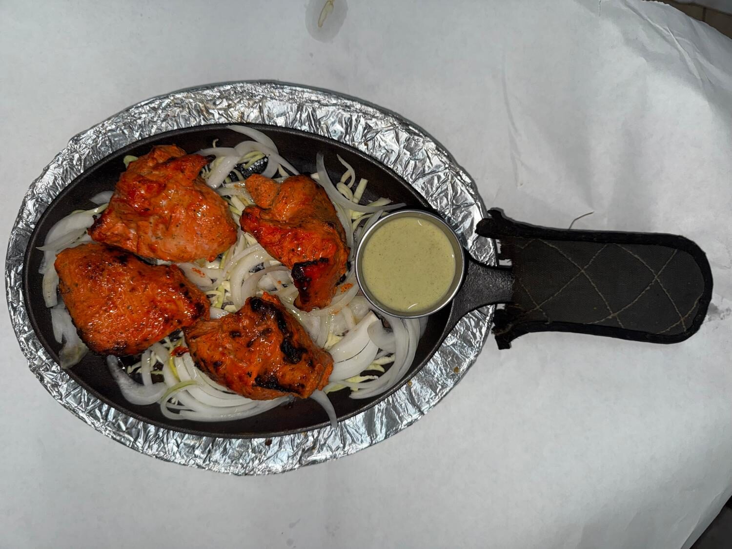 Chicken tikka sizzler with onions and house-made green chutney