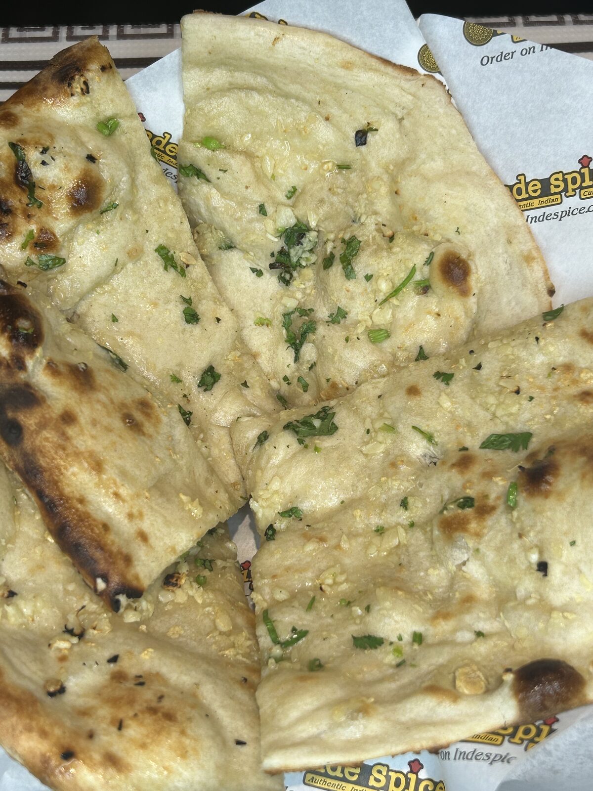 Garlic naan brushed with butter, garlic and fresh cilantro