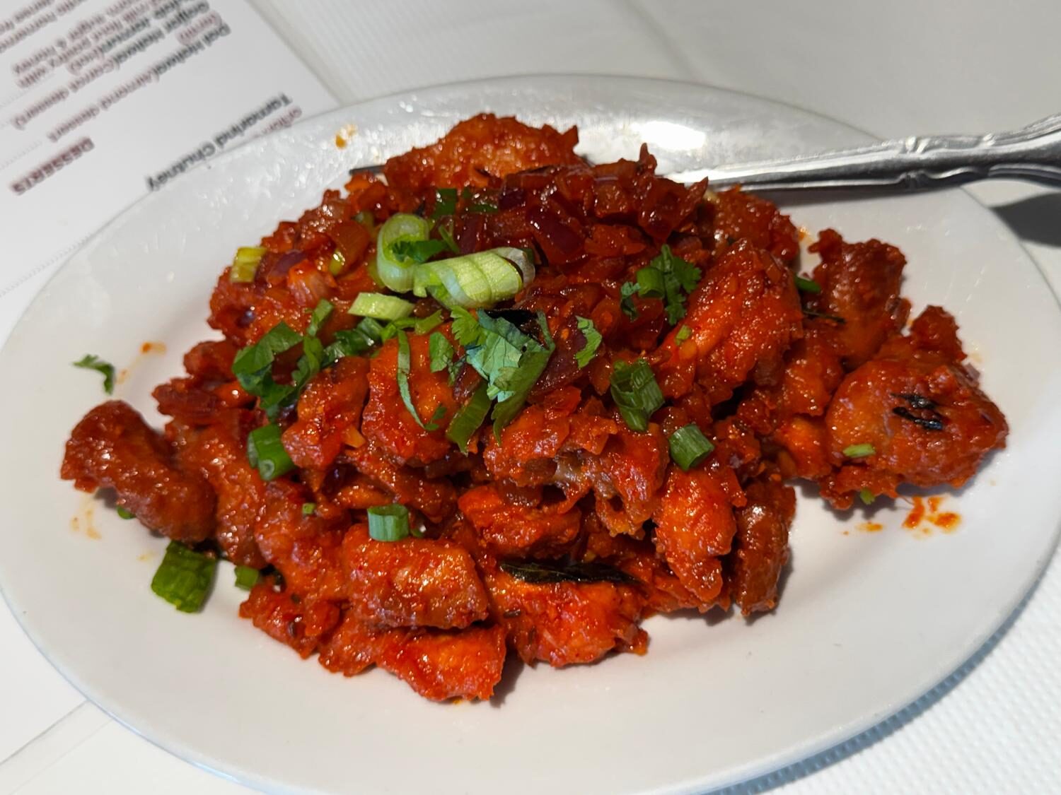 Indo-Chinese dry chilli chicken with curry leaves and scallions